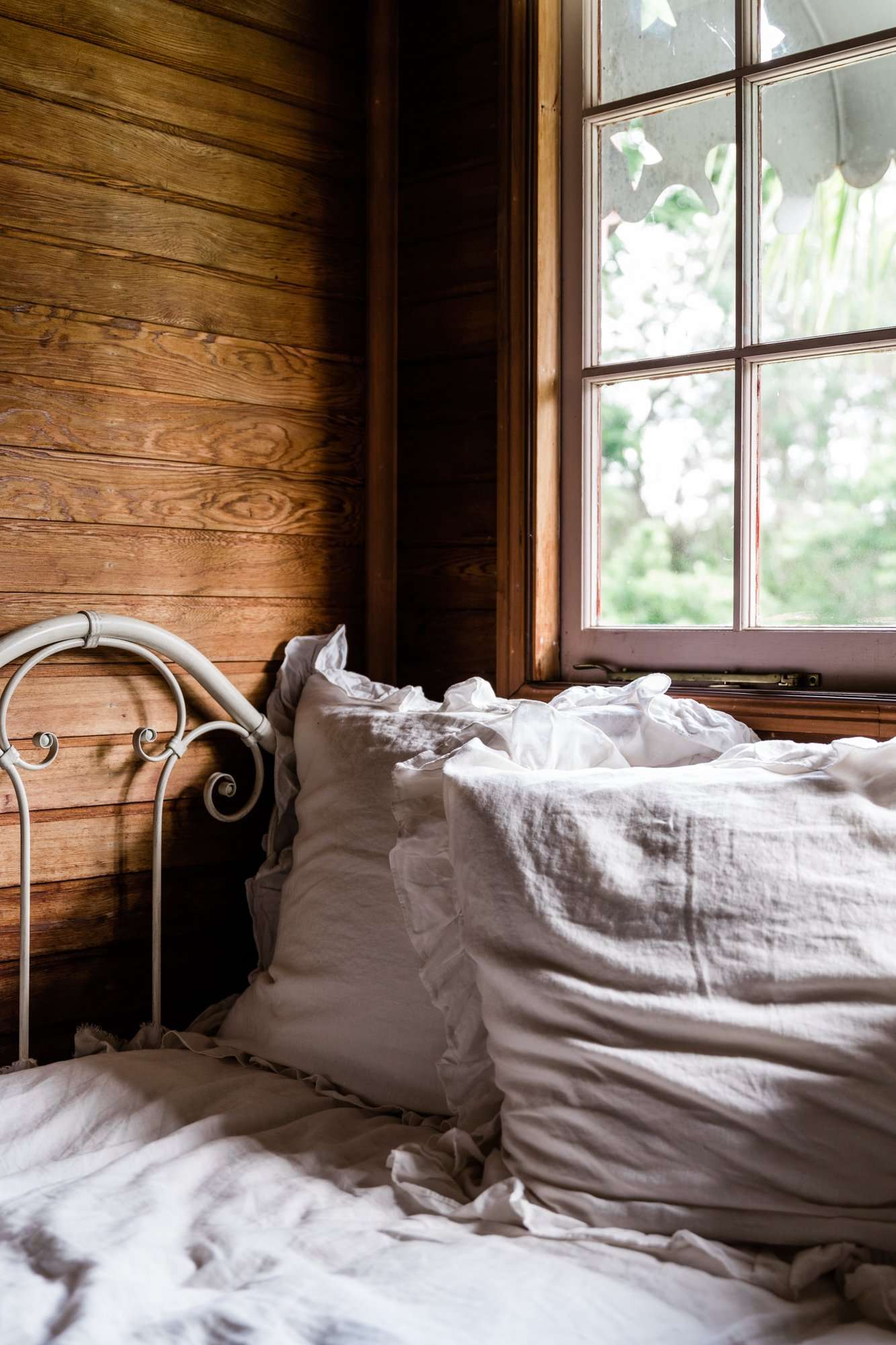 Reading area attached to the Bowerbird Cottage at Maiala Park Lodge - an accommodation on Mount Glorious - The windows present a view of the rainforest trees